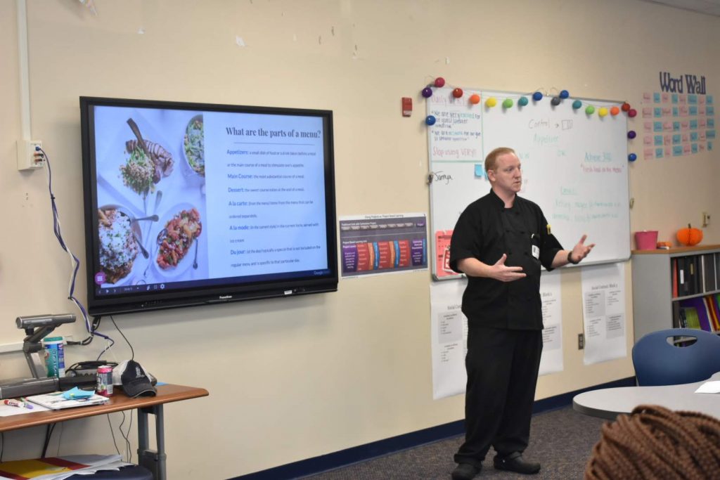 Chef Andrew Boyd explaining culinary lingo at Burke High School
