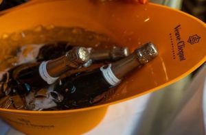 Bottle of Veuve Clicquot champagne in an orange bucket filled with ice
