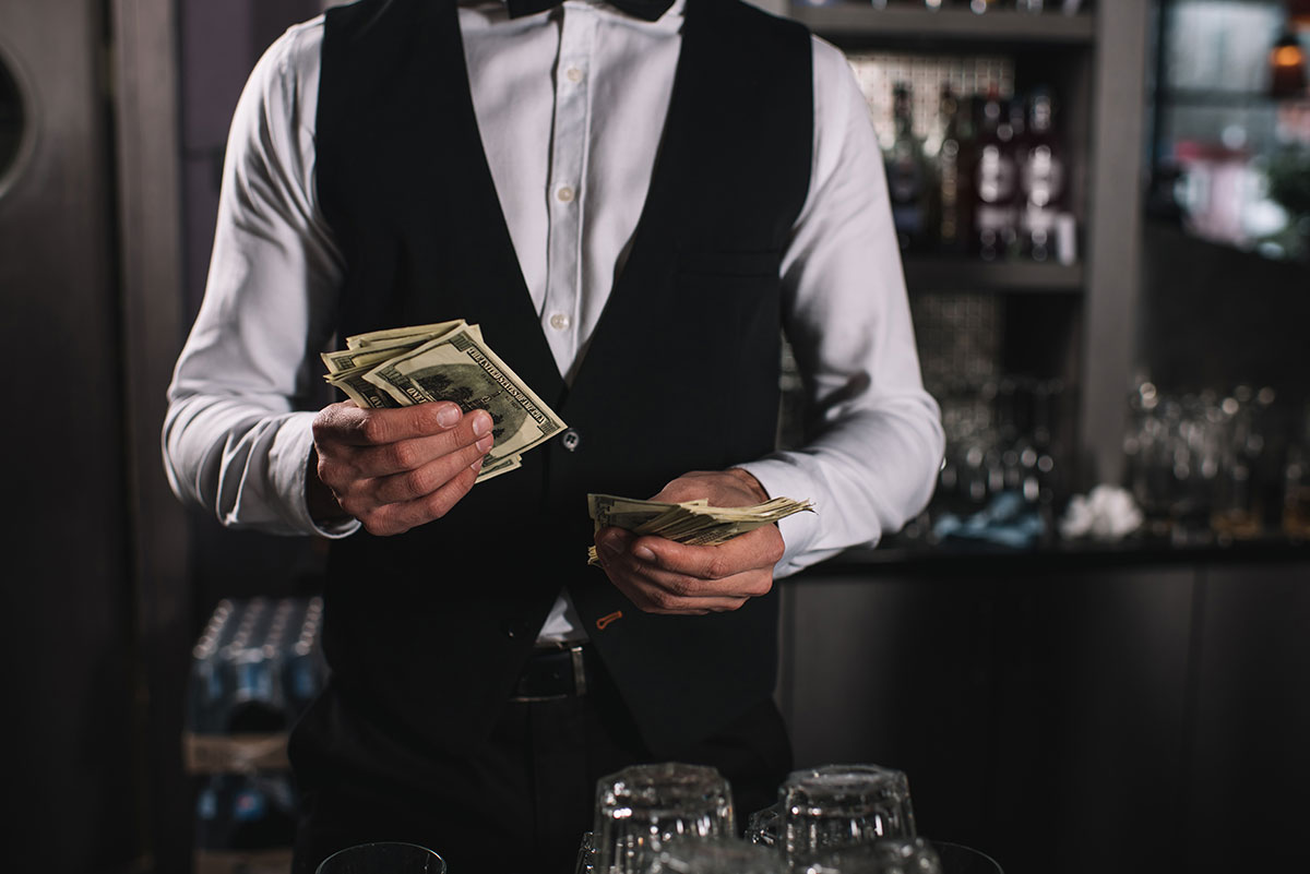 bartender at catered event counting money